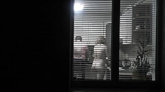Peeping. Voyeur. Neighbor pervert voyeur in evening on street looks out window as naked sexy neighbo Thumb