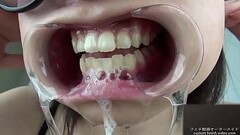 A woman shows her gums and sputs saliva Thumb